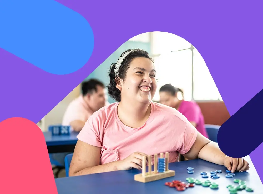 A young lady smiling and using a coloured abacus